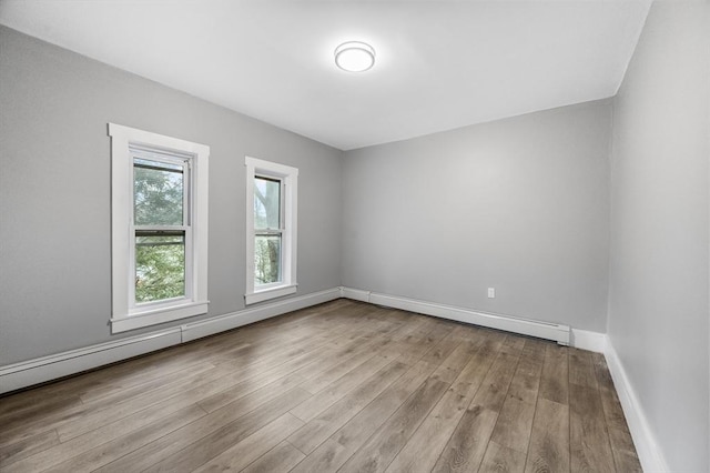 empty room with wood finished floors and baseboards