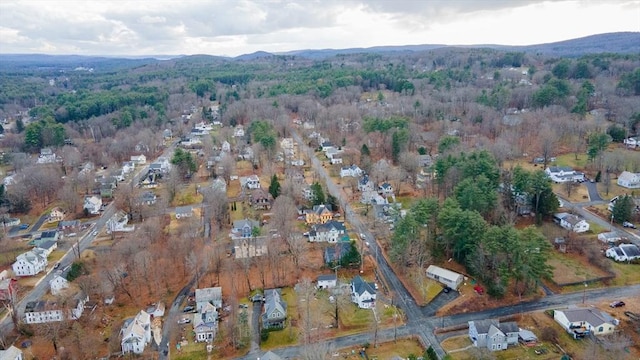 drone / aerial view featuring a mountain view and a wooded view