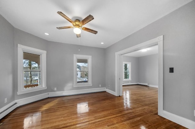 unfurnished room featuring ceiling fan, baseboards, recessed lighting, wood finished floors, and a baseboard radiator