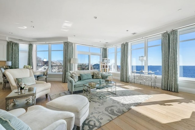 sunroom / solarium with a water view