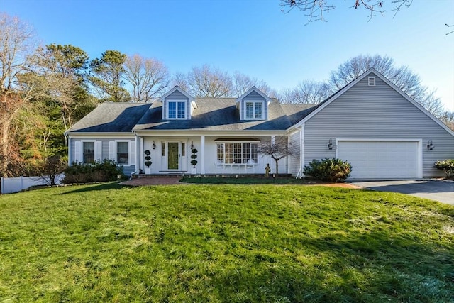 cape cod house with a front yard and a garage