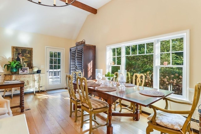 dining room featuring beam ceiling, plenty of natural light, high vaulted ceiling, and light wood-type flooring