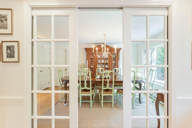 dining space featuring carpet floors and a notable chandelier