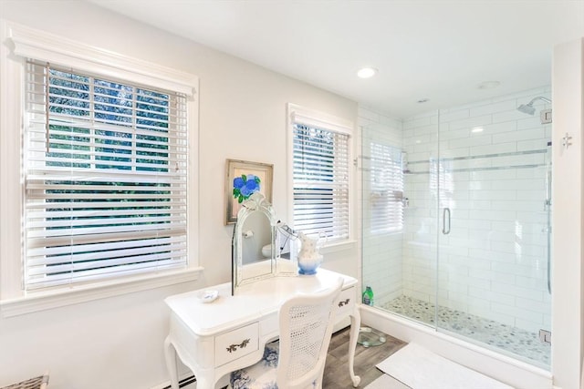 bathroom featuring hardwood / wood-style floors and walk in shower