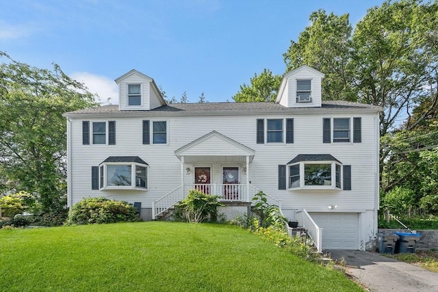22 Washington St, Methuen, MA 01844 - view of front facade with a garage, asphalt driveway, and a front lawn