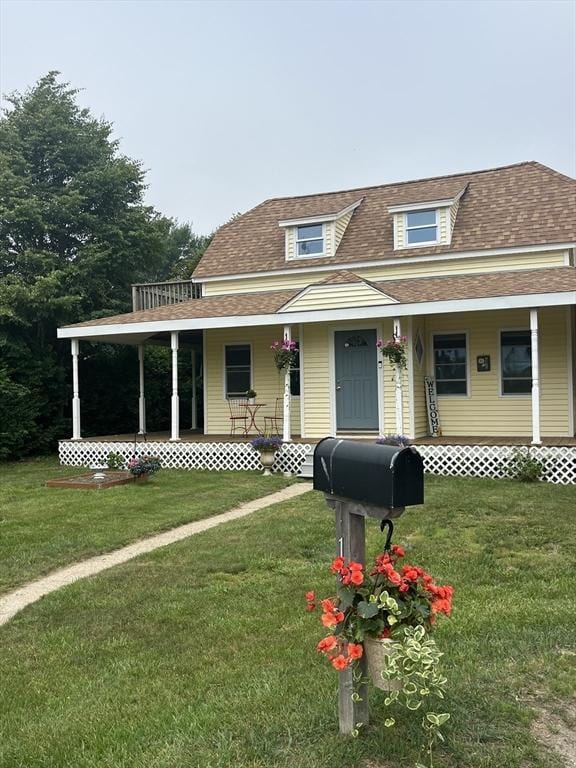 13 Harrison Ave, Bourne, MA 02532 - view of front facade featuring a porch, a front yard, and a shingled roof