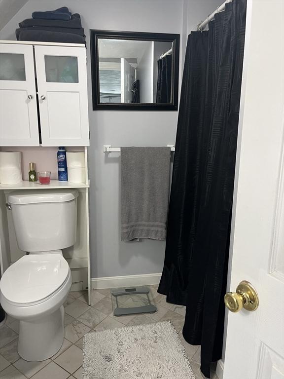 13 Harrison Ave, Bourne, MA 02532 - bathroom featuring toilet and a shower with shower curtain