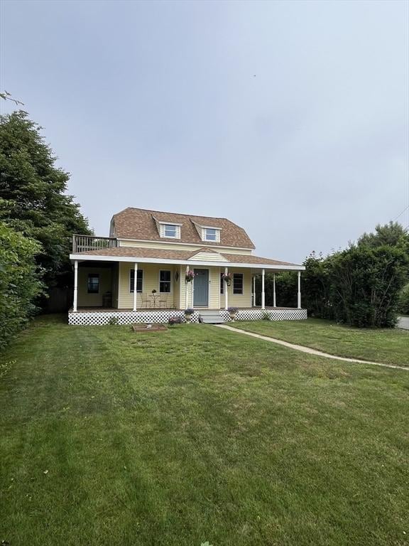 13 Harrison Ave, Bourne, MA 02532 - farmhouse featuring a porch and a front yard
