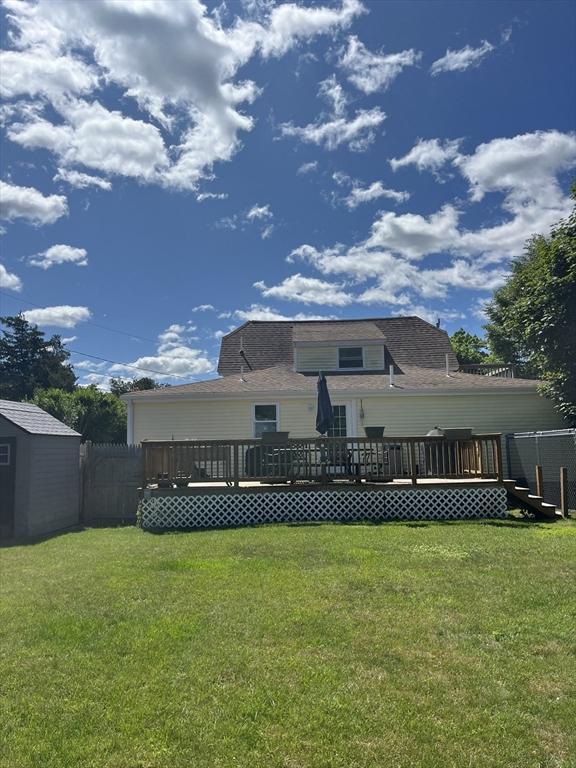 13 Harrison Ave, Bourne, MA 02532 - rear view of property featuring a storage shed and a deck