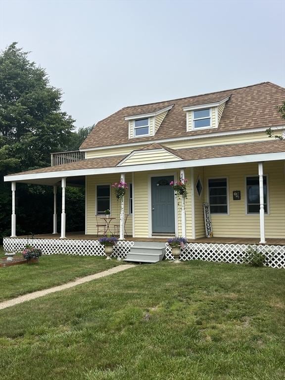 13 Harrison Ave, Bourne, MA 02532 - view of front of house featuring covered porch, roof with shingles, and a front lawn