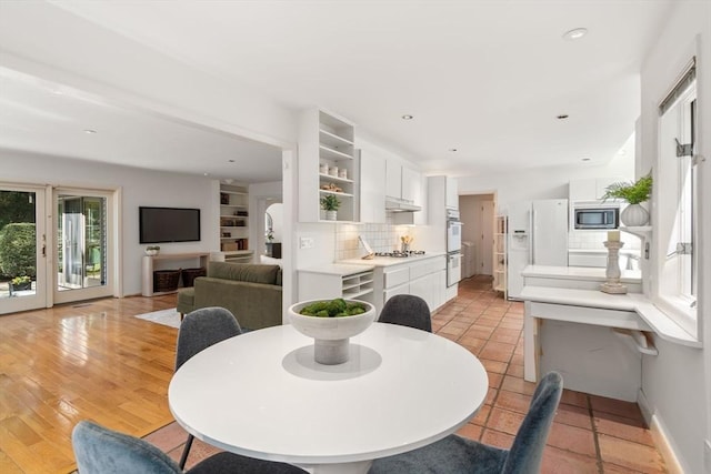 dining room with recessed lighting and baseboards