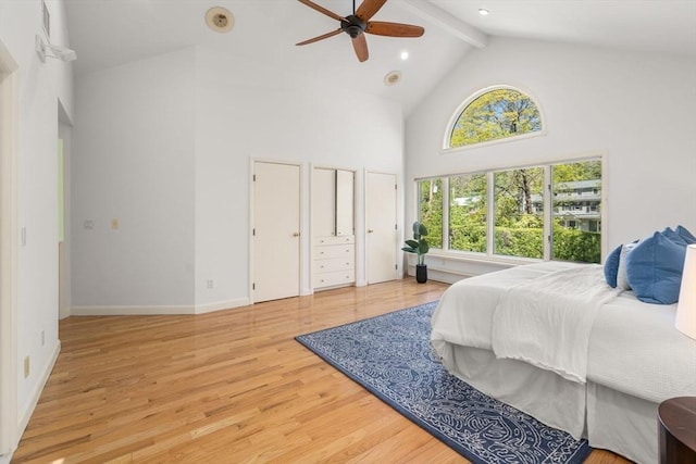 bedroom featuring beam ceiling, high vaulted ceiling, a ceiling fan, baseboards, and light wood-type flooring