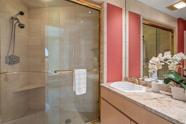 bathroom with vanity, visible vents, and a shower stall