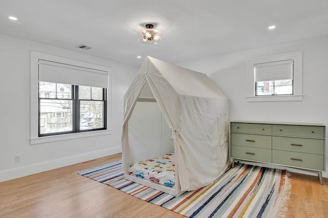 bedroom featuring recessed lighting, visible vents, light wood-style flooring, and baseboards