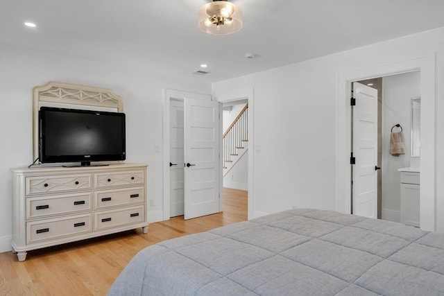 bedroom with baseboards, light wood-type flooring, visible vents, and recessed lighting