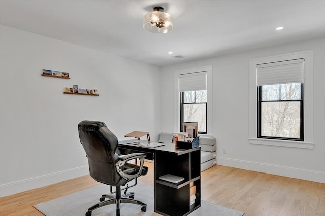 home office with recessed lighting, light wood-type flooring, and baseboards