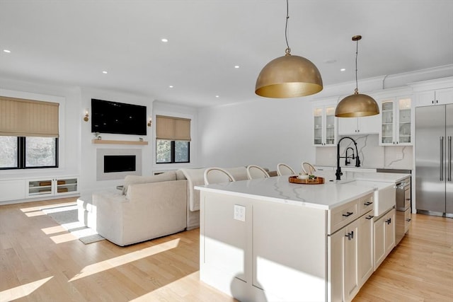 kitchen featuring light wood-type flooring, white cabinets, and stainless steel built in fridge