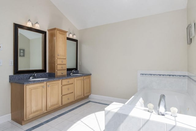 full bath with baseboards, double vanity, tile patterned floors, and a sink