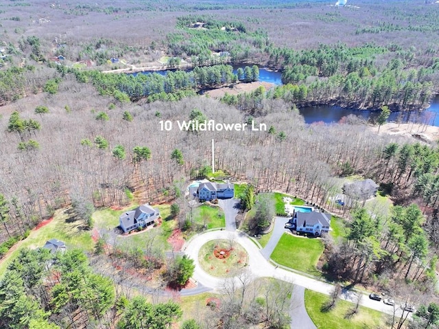 aerial view featuring a water view and a wooded view