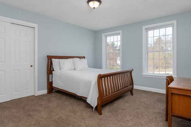 bedroom featuring baseboards and carpet