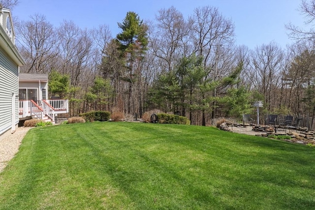 view of yard featuring a patio area and an outdoor fire pit