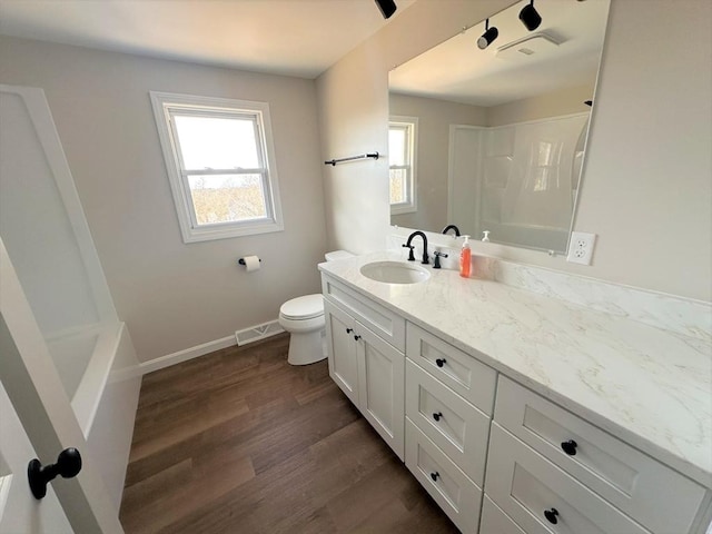 full bath with visible vents, baseboards, walk in shower, toilet, and wood finished floors