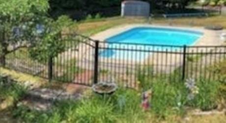 view of swimming pool featuring a fenced in pool and fence