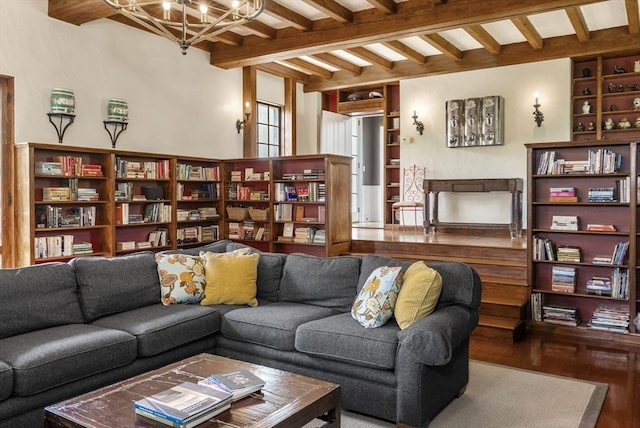 living area featuring beamed ceiling, a notable chandelier, built in features, and wood finished floors