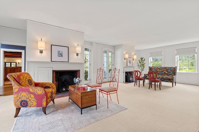 living room featuring light carpet and a fireplace