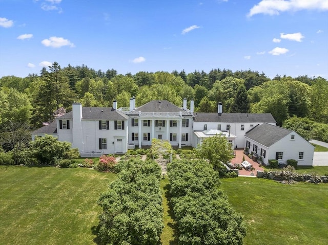 drone / aerial view featuring a wooded view
