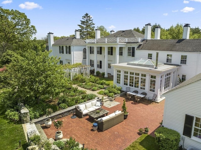 rear view of house with an outdoor hangout area and a patio