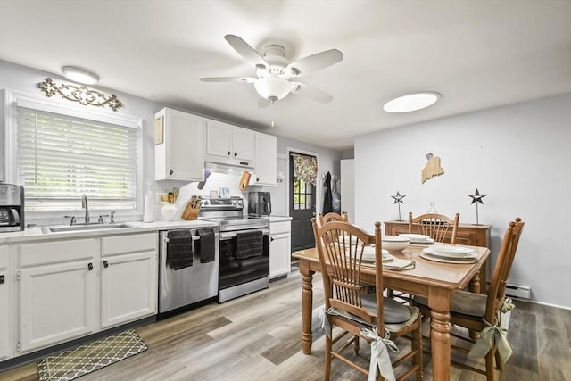 231 Georgetown Rd, Boxford, MA 01921 - kitchen with stainless steel appliances, a sink, a ceiling fan, under cabinet range hood, and white cabinetry