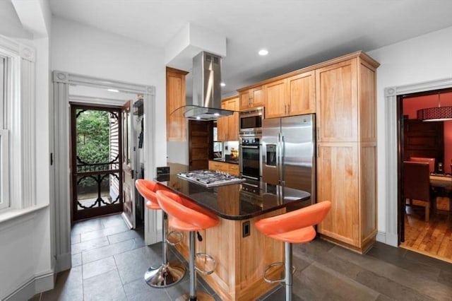 5 Willow Ave, Somerville, MA 02144 - kitchen featuring island exhaust hood, appliances with stainless steel finishes, a breakfast bar area, recessed lighting, and a peninsula