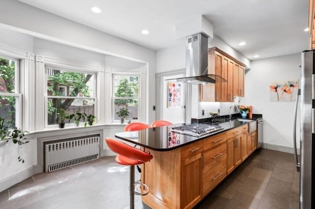 5 Willow Ave, Somerville, MA 02144 - kitchen with radiator heating unit, wall chimney exhaust hood, appliances with stainless steel finishes, tile patterned floors, and recessed lighting