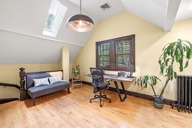 5 Willow Ave, Somerville, MA 02144 - office featuring radiator heating unit, wood finished floors, vaulted ceiling, a skylight, and plenty of natural light