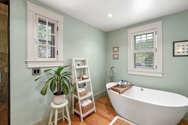 5 Willow Ave, Somerville, MA 02144 - bathroom featuring plenty of natural light, wood finished floors, a freestanding tub, recessed lighting, and baseboards