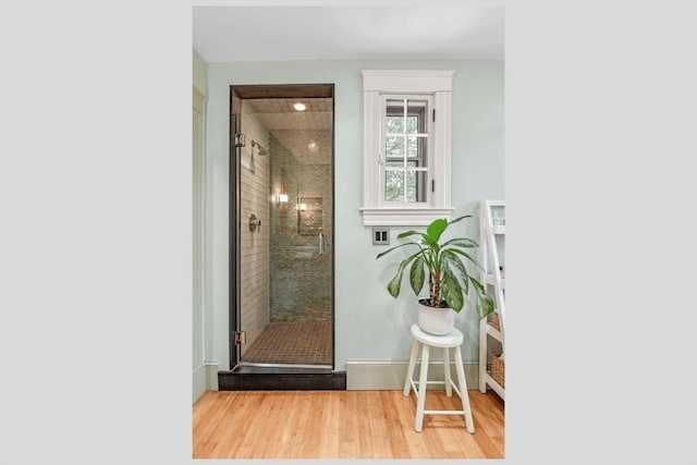 5 Willow Ave, Somerville, MA 02144 - bathroom with wood finished floors, a stall shower, and baseboards