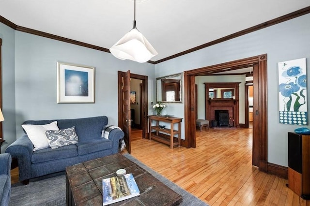 5 Willow Ave, Somerville, MA 02144 - living area with light wood-type flooring, crown molding, a fireplace, and baseboards