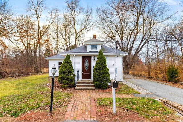 bungalow-style home featuring a front yard