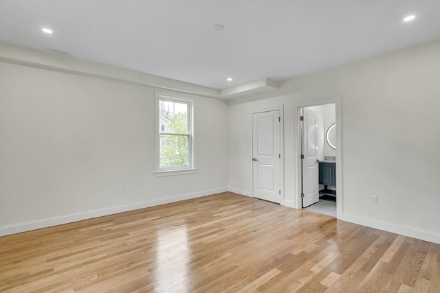 38 Green St Unit 38, Watertown, MA 02472 - unfurnished bedroom featuring light wood-style floors, baseboards, recessed lighting, and ensuite bath