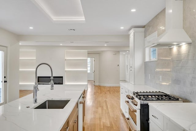 38 Green St Unit 38, Watertown, MA 02472 - kitchen with premium range hood, a sink, white gas stove, tasteful backsplash, and light wood finished floors