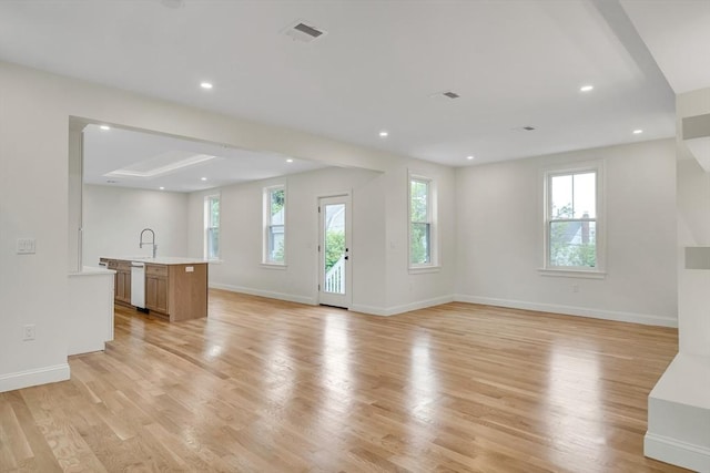 38 Green St Unit 38, Watertown, MA 02472 - unfurnished living room featuring light wood finished floors, baseboards, a sink, and recessed lighting