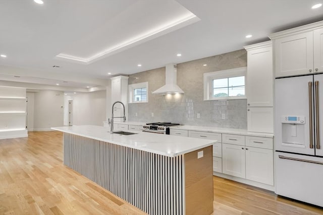 38 Green St Unit 38, Watertown, MA 02472 - kitchen featuring white fridge with ice dispenser, a sink, high end stainless steel range, white cabinetry, and wall chimney exhaust hood