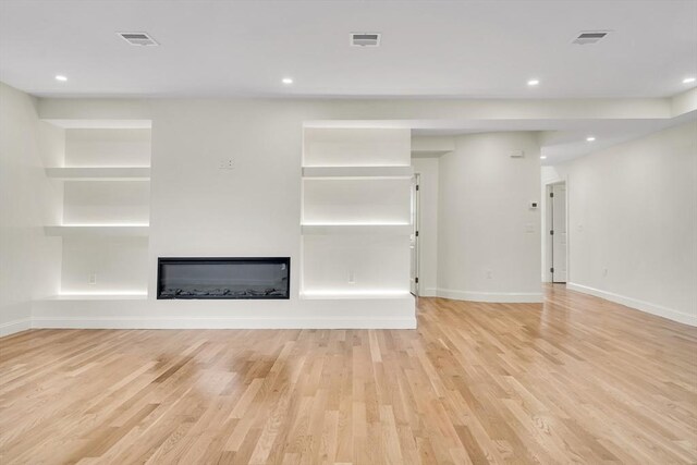 38 Green St Unit 38, Watertown, MA 02472 - unfurnished living room featuring light wood-style floors, a glass covered fireplace, baseboards, and recessed lighting