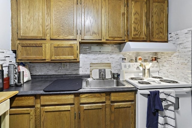 74 Beach St Unit 1-3, Woburn, MA 01801 - kitchen with electric stove, custom exhaust hood, backsplash, dark countertops, and brown cabinetry