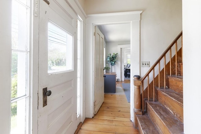 831 Main St, Dennis, MA 02638 - foyer entrance with plenty of natural light, light wood finished floors, and stairway