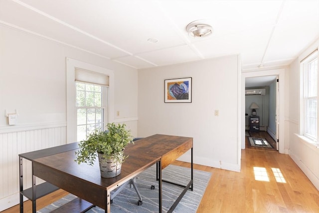 831 Main St, Dennis, MA 02638 - dining space featuring a wall mounted AC, light wood-type flooring, wainscoting, and a baseboard heating unit