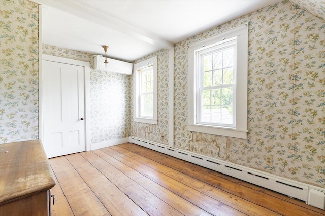 831 Main St, Dennis, MA 02638 - unfurnished dining area featuring a baseboard heating unit and light wood-style floors