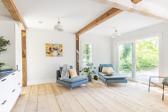 831 Main St, Dennis, MA 02638 - sitting room with beamed ceiling, light wood-style flooring, and baseboards