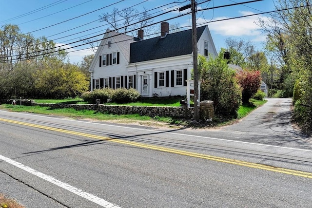 831 Main St, Dennis, MA 02638 - view of front of home featuring roof with shingles, a gambrel roof, and a chimney